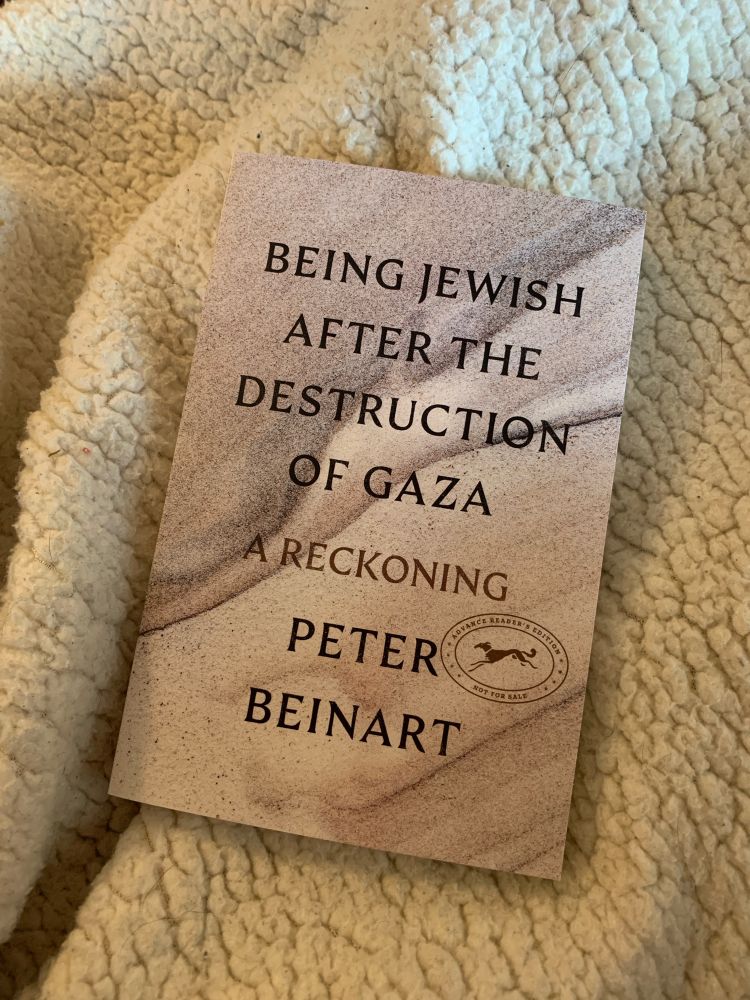 The cover of “Being Jewish After the Destruction of Gaza” by Peter Beinart on a woolly blanket