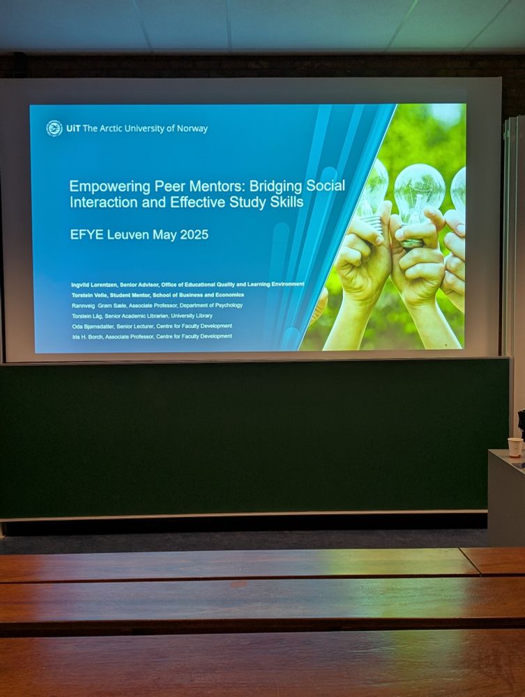 A PowerPoint slide in a large lecture theatre that reads: Empowering Peer Mentors: Bridging Social Interaction and Effective Study Skills.