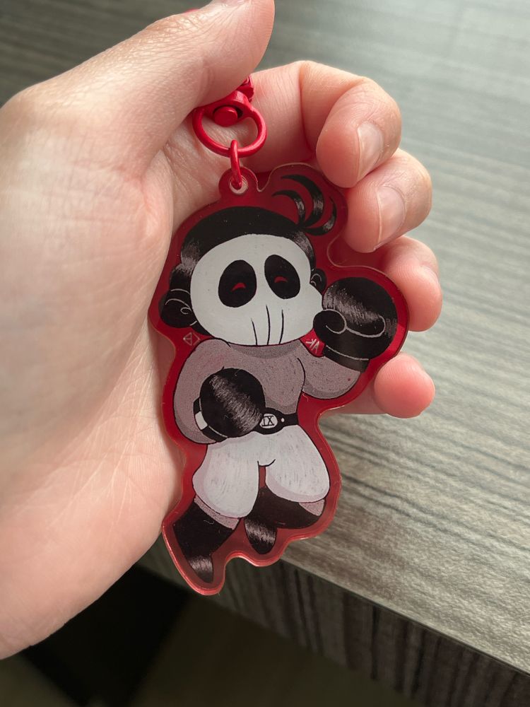 Keychain being held with a hand with the keychainf facing back