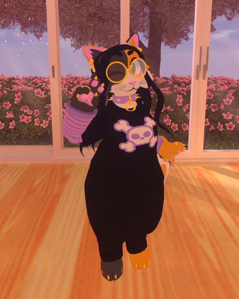 Letoshta in a black tshirt with a skull and crossbones print on it, with a pink and purple longsleeve underneath. She has black hoggers on, gold rimmed glasses as well. She is winking at you and holding a peace sign up next to the winking eye.