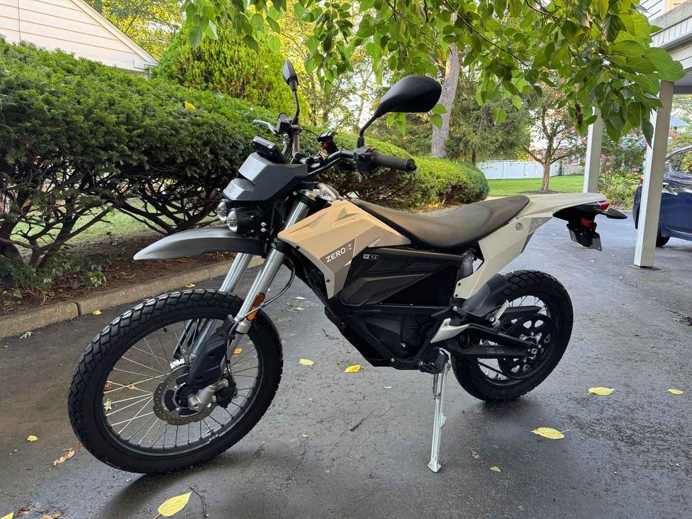 Electric motorcycle parked on a suburban driveway. 