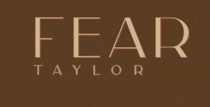 Beige text on a brown background that says “FEAR TAYLOR”
