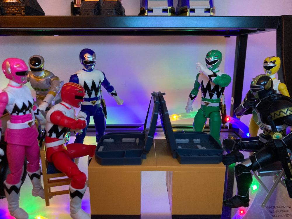 The Lost Galaxy Power Rangers/Gingaman play Battleship. No one knows how to play and so far everyone is cheating. 

Also, the Silver Space Ranger/MegaSilver is there on his bike because he didn't get to hang out during the crossover. He is disappointing in all the cheating going on. He's probably gonna leave soon to grab some buffalo crunchers