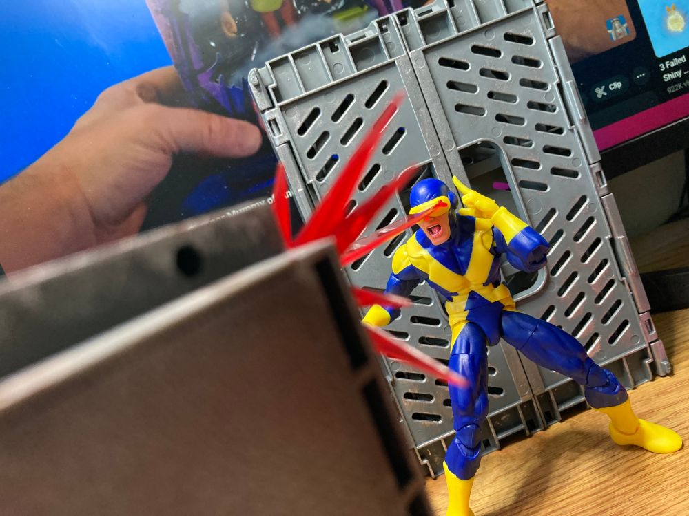 Cyclops shoots a metal box with his eye blasts. He hates metal. He and Colossus aren't on speaking terms.