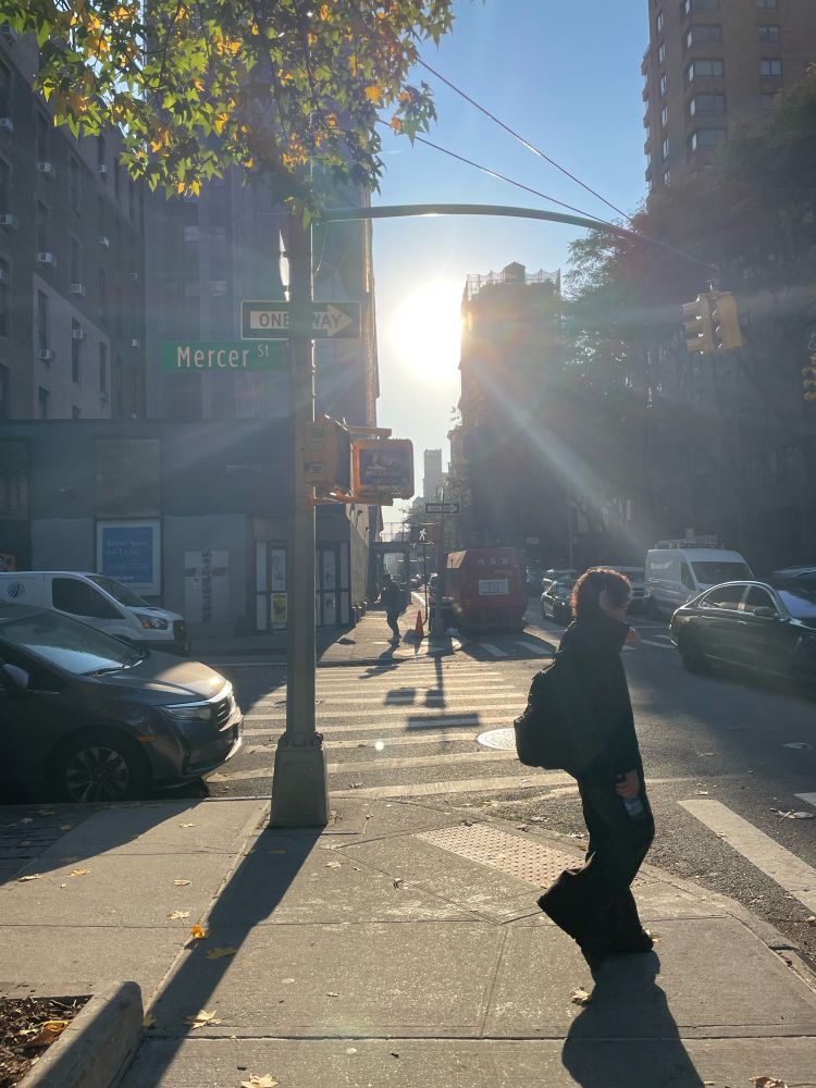 3rd Street in Manhattan. The sun glares between the buildings and casts extra long shadows
