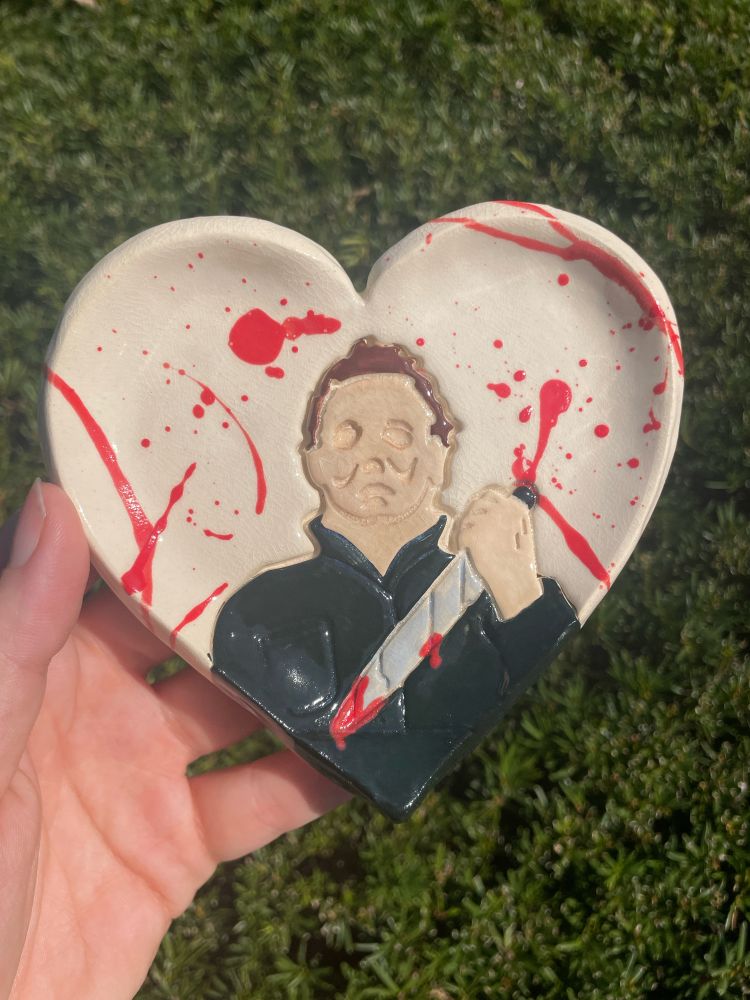 ceramic heat dish with michael myers imprint accented with red glaze splatter