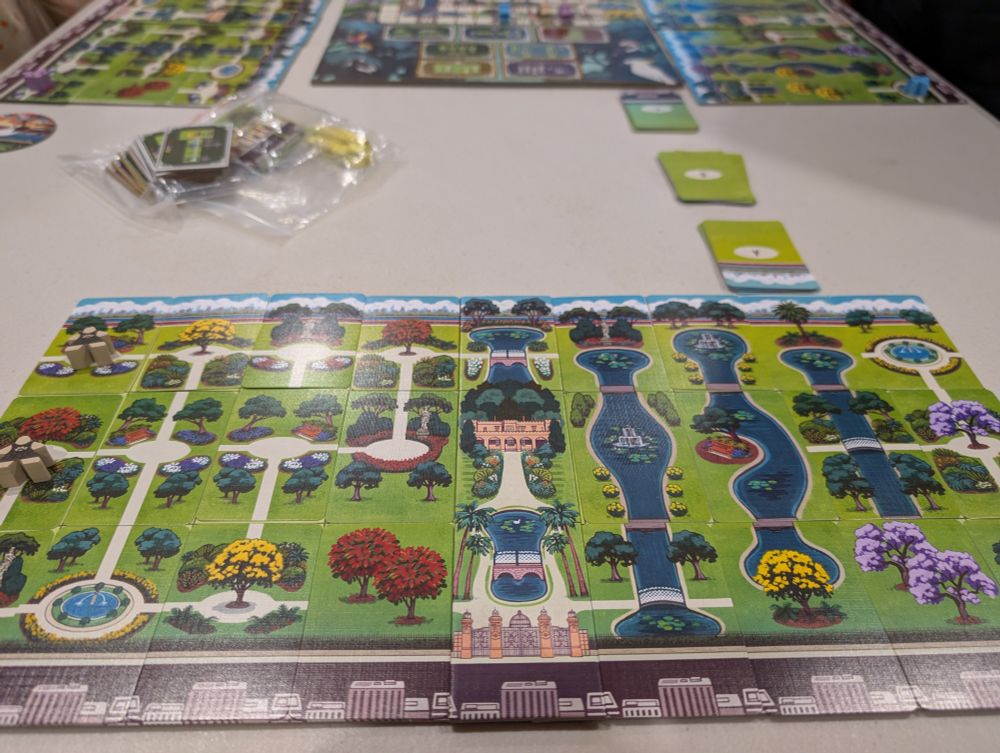 A (not very well framed) photograph of the finished player board for a round of The Gardens, a board game about enjoying things to see in Sydney's Botanic Gardens.