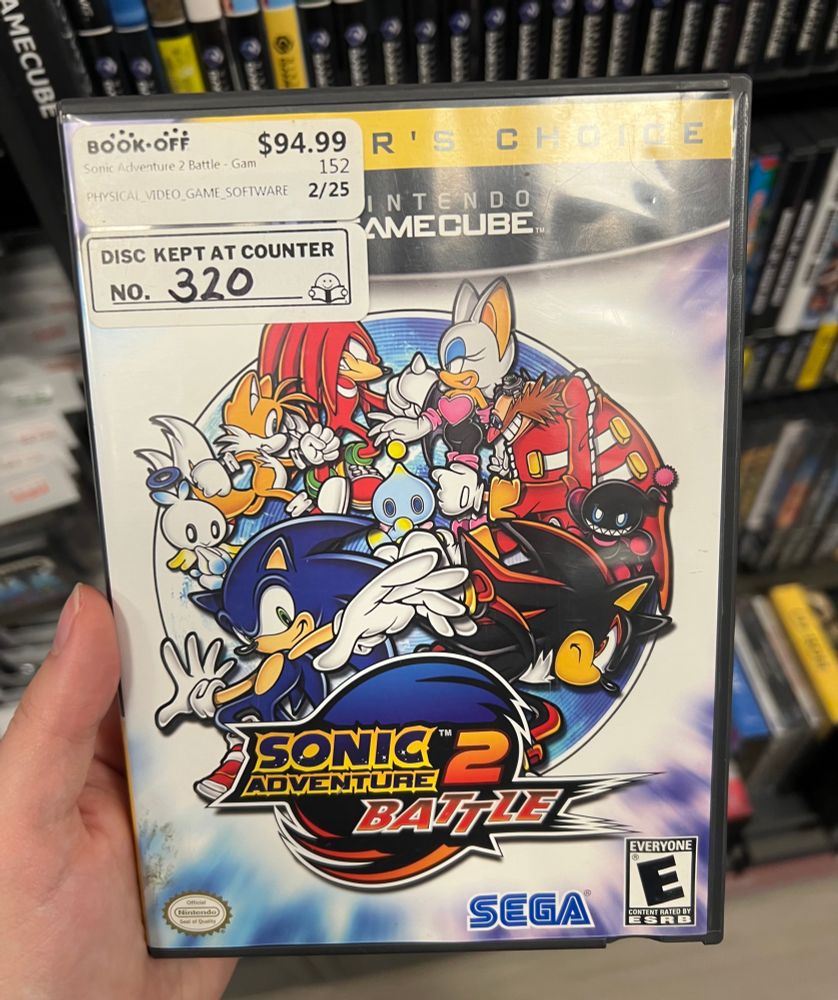 my left hand holding sonic adventure 2 battle for gamecube rectangular disc case 