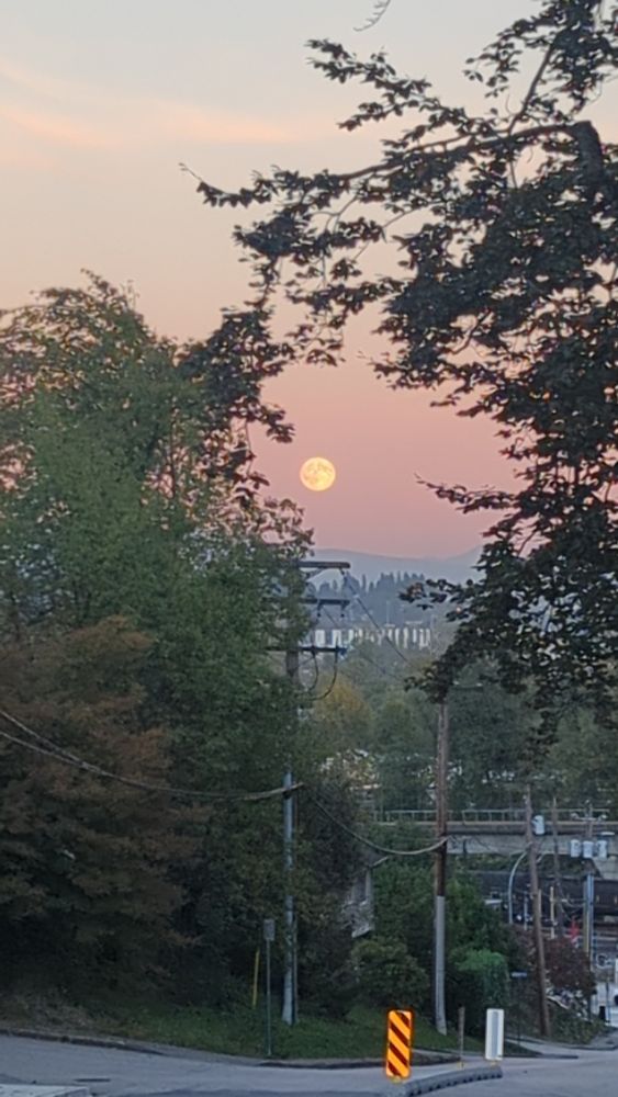 Big moon rises while sun is going down
