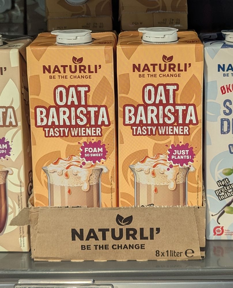 Supermarket shelf with cartons of Naturli Oat Barista drinks called "Tasty Wiener".