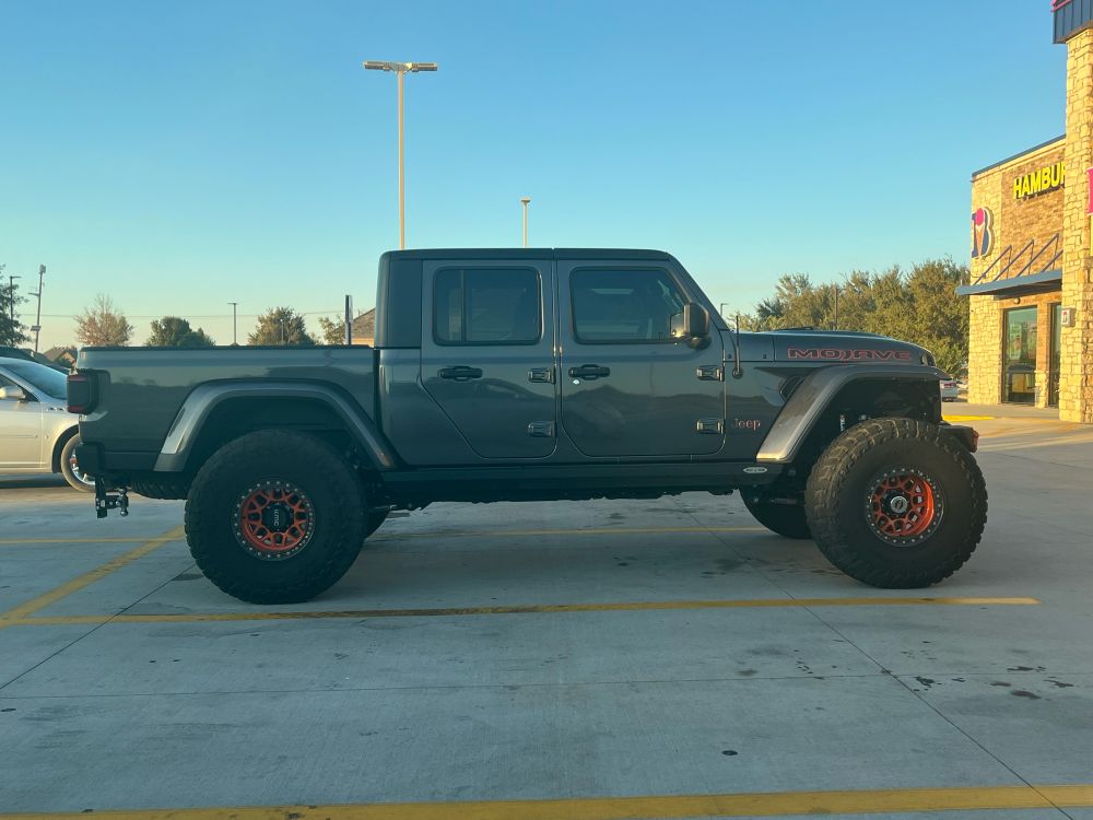 An absurdly large Jeep four-door lifted truck that looks like a child’s toy.