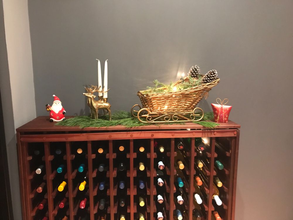 Wine rack with Santa, reindeer candle holders and a golden sleigh.  