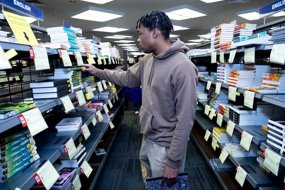 A male student picks up textbooks in the Santa Rosa Junior College's bookstore. 
