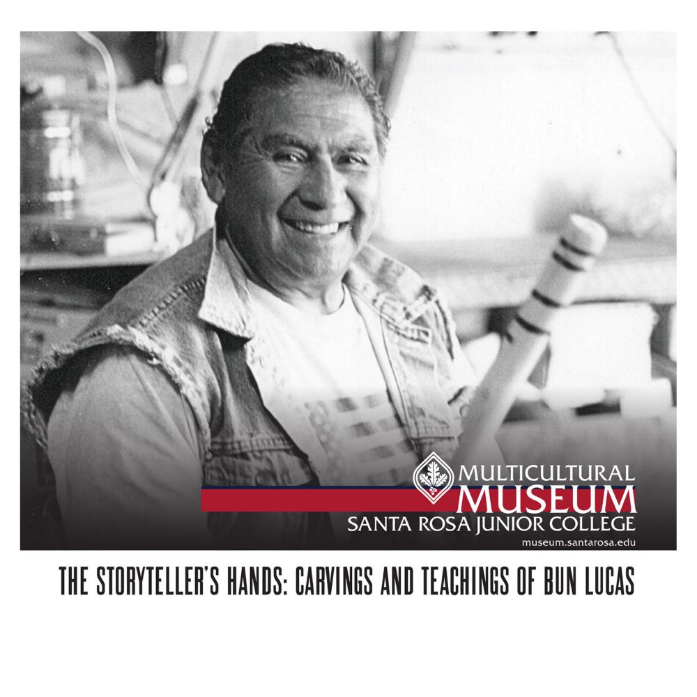 Black and white portrait photo of Stewarts Point/Kashia Pomo community member and artist Bun Lucas, smiling at the camera. The photo illustrates the upcoming exhibit The Storyteller's Hands: Carvings and Teachings of Bun Lucas, held at the SRJC's Multicultural Museum. 
