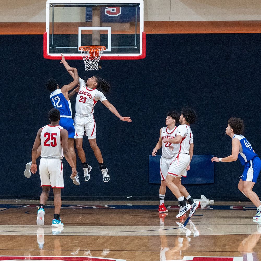 Men's basketball game at SRJC Haehl Pavillion. The SRJC Bear Cubs, wearing white, are playing against Consumnes College, wearing blue. 