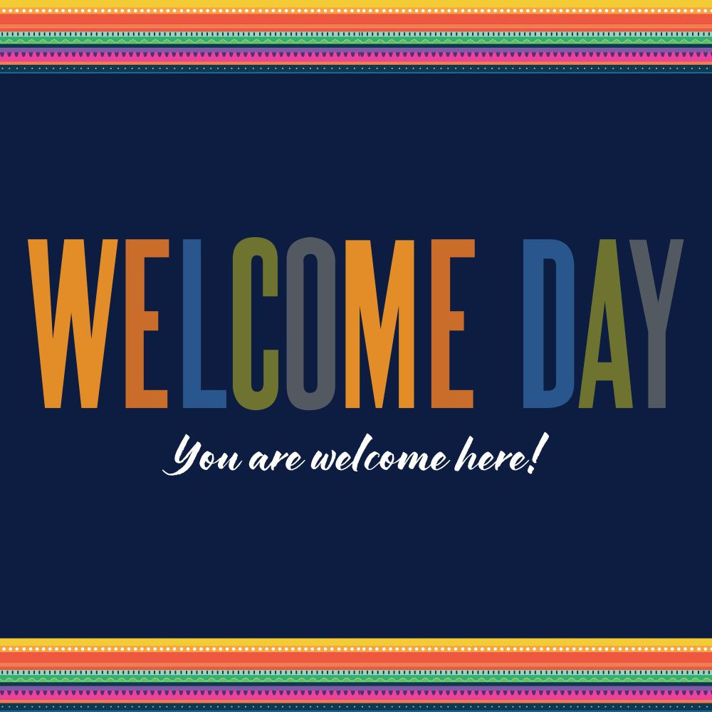 Poster on a navy blue background with a multicolor border on top and bottom. The message says Welcome Day - You are welcome here!