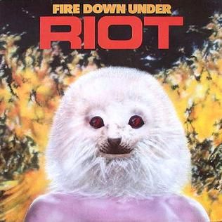 Cover art for hard rock band Riot's 1981 album Fire Down Under. Features their mascot character Johnny the Mighty Tior, a crimson coloured animorphic caveman with the head of a baby seal.