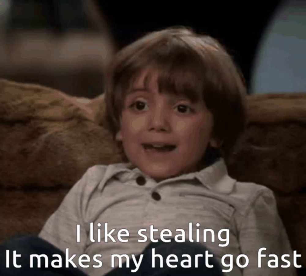 a young boy is sitting on a couch with the words " i like stealing it makes my heart go fast "