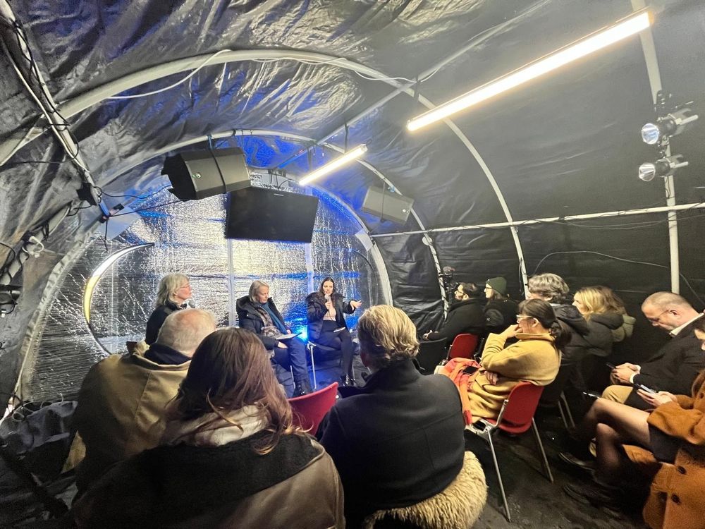 An image showing speakers talking to attendees during the Science to Action event
