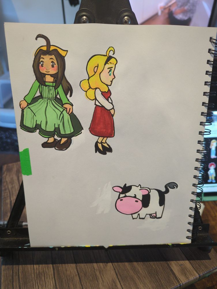 a photograph of my sketchbook. cecilia, Muffy/molly, and a cow have been painted.