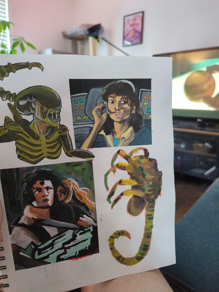 a photograph of my sketchbook with a tv blurred in the background. the sketchbook page has paintings of the xenomorph, ellen ripley, and a facehugger, all done in acrylic. the tv in the background shows a still from alien: earth 