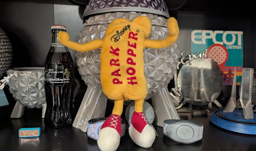 A stuffed bean bag version of the Disney park hopper promotional humanoid thing from the '90s. It's in front of a bunch of old Epcot shit and what not. 