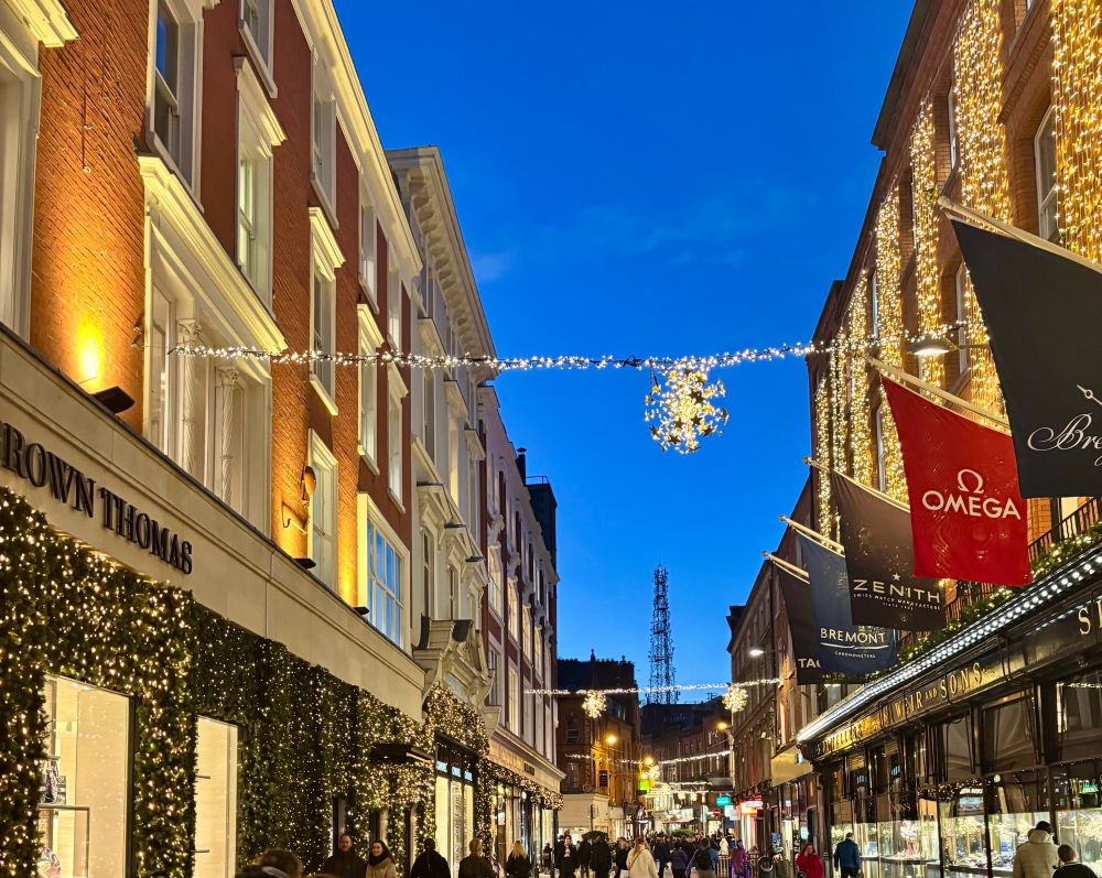Xmas lights on Grafton St Dublin with a dark blue evening sky in the background 