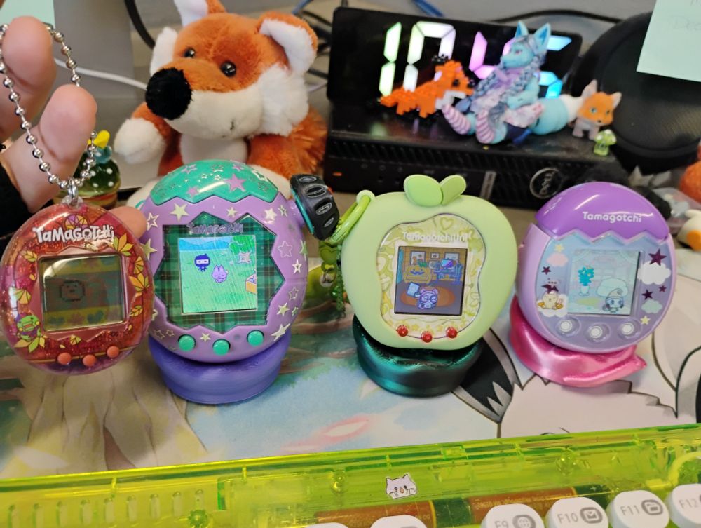 A set of Tamagochis on little chairs.