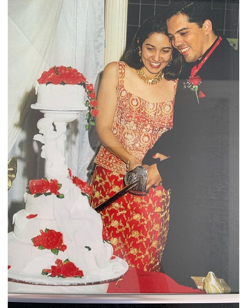 Photo of my wedding; Shanel and I are cutting the wedding cake using my great-grandfather's ceremonial sword.