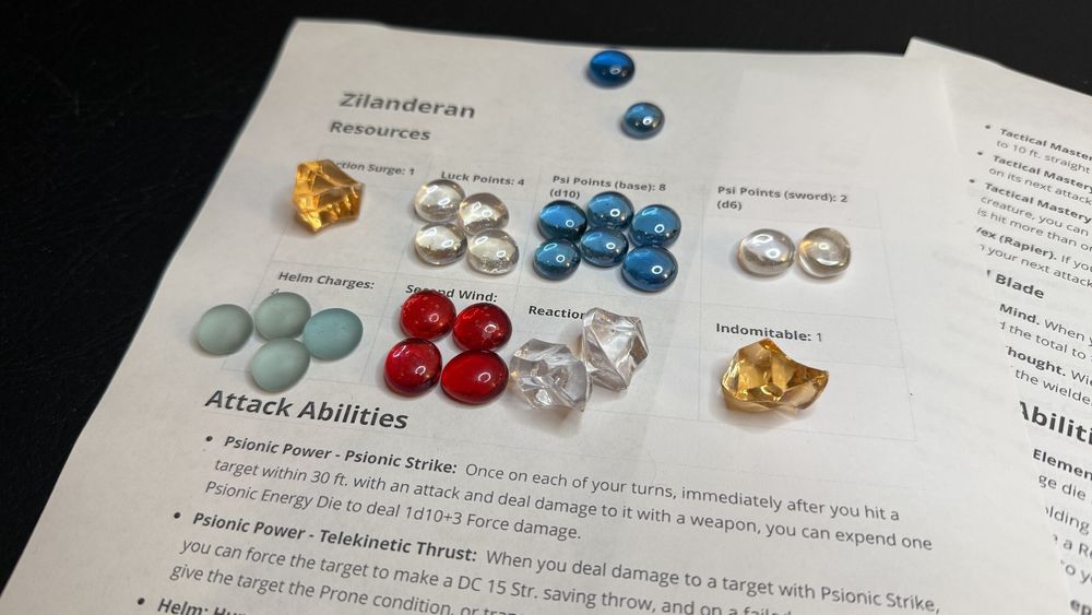 A sheet with labels for resources, along with tokens representing those tokens.