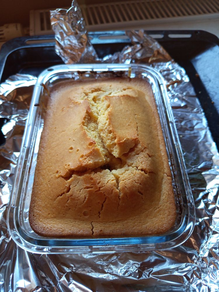 freshly made cornbread, cracked at the top, still in the baking dish