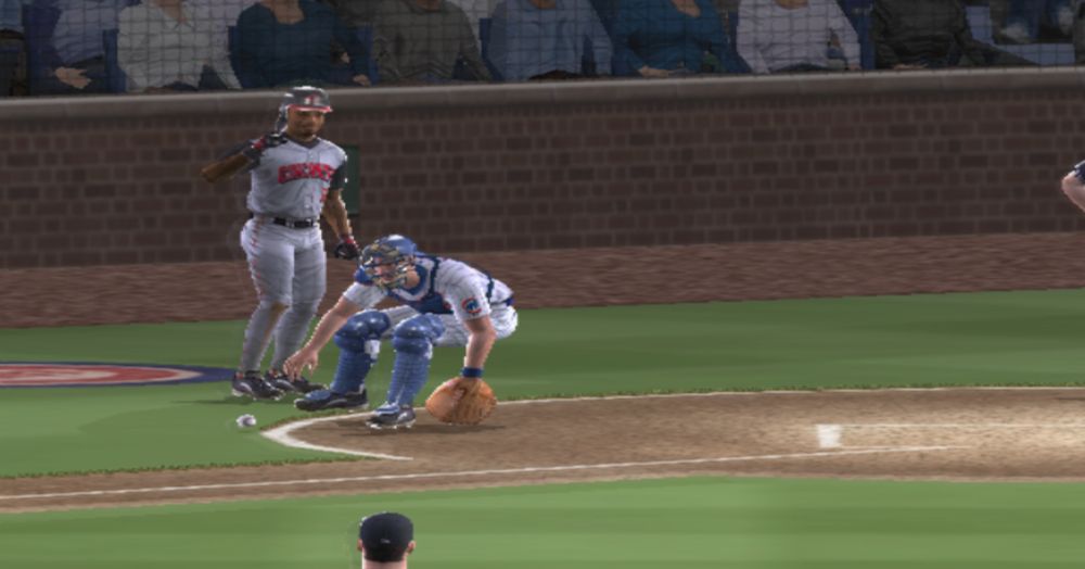 screenshot from ps2 game mvp baseball, catcher chasing a wild pitch as ken griffey jr steps out of the box to get out of the way
