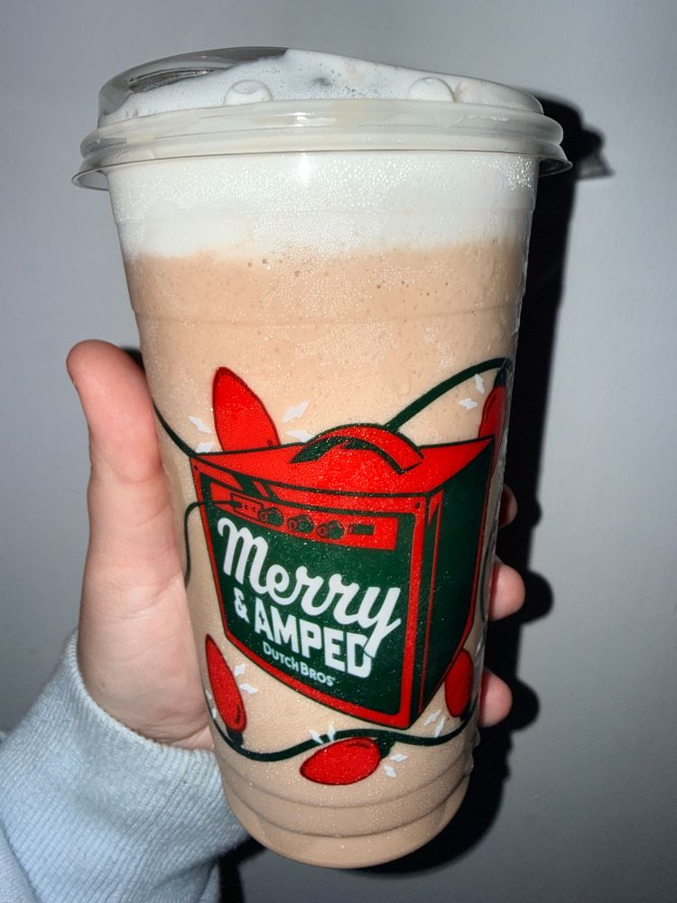 my coffee that says “merry & amped” on the cup