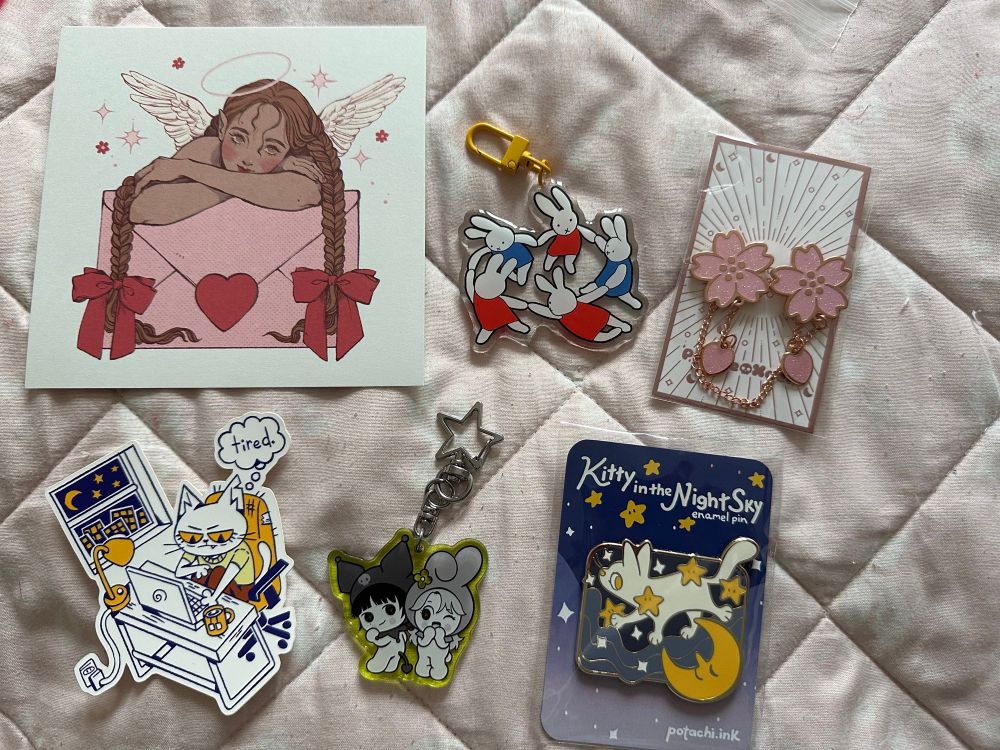 Photo of merch haul from Flamecon 