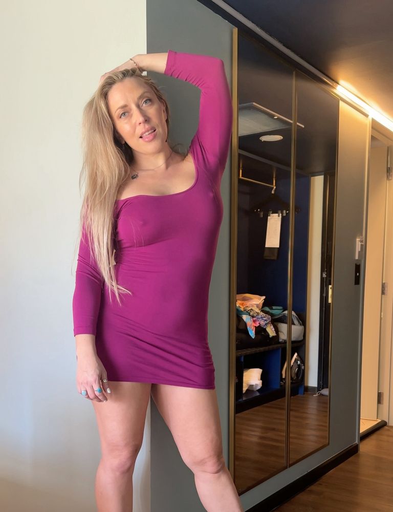 Woman in maroon dress with high heel stilettos on.