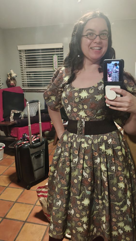 Mirror selfie from my bedroom at my parents with suitcase in the background. I'm wearing my dinosaur sugar cookie dress!! 