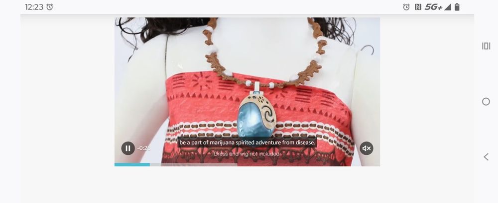 Screenshot of a video of a light up heart of te fiti necklace from Moana. The caption reads "be a part of Marijuana spirited adventure from disease" 