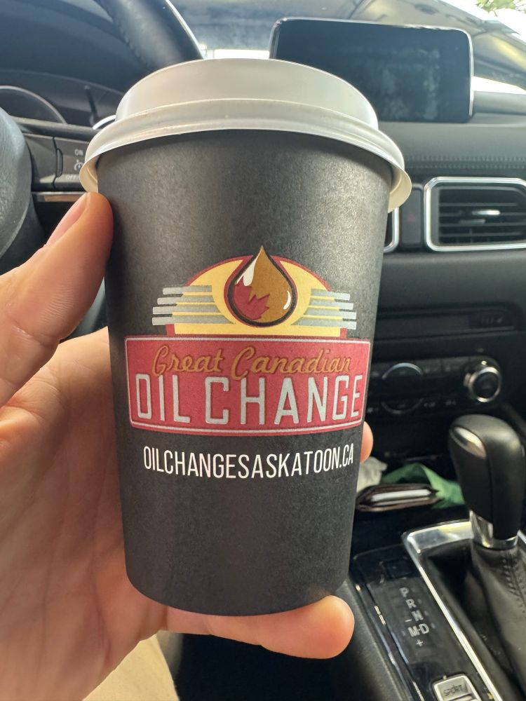 Disposable Coffee cup baring the noble insignia of the Great Canadian Oil Change company.