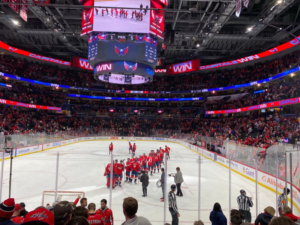 Shot of the Washington Capitals in red jerseys celebrating on the ice after a win at home 5-1 against Columbus 