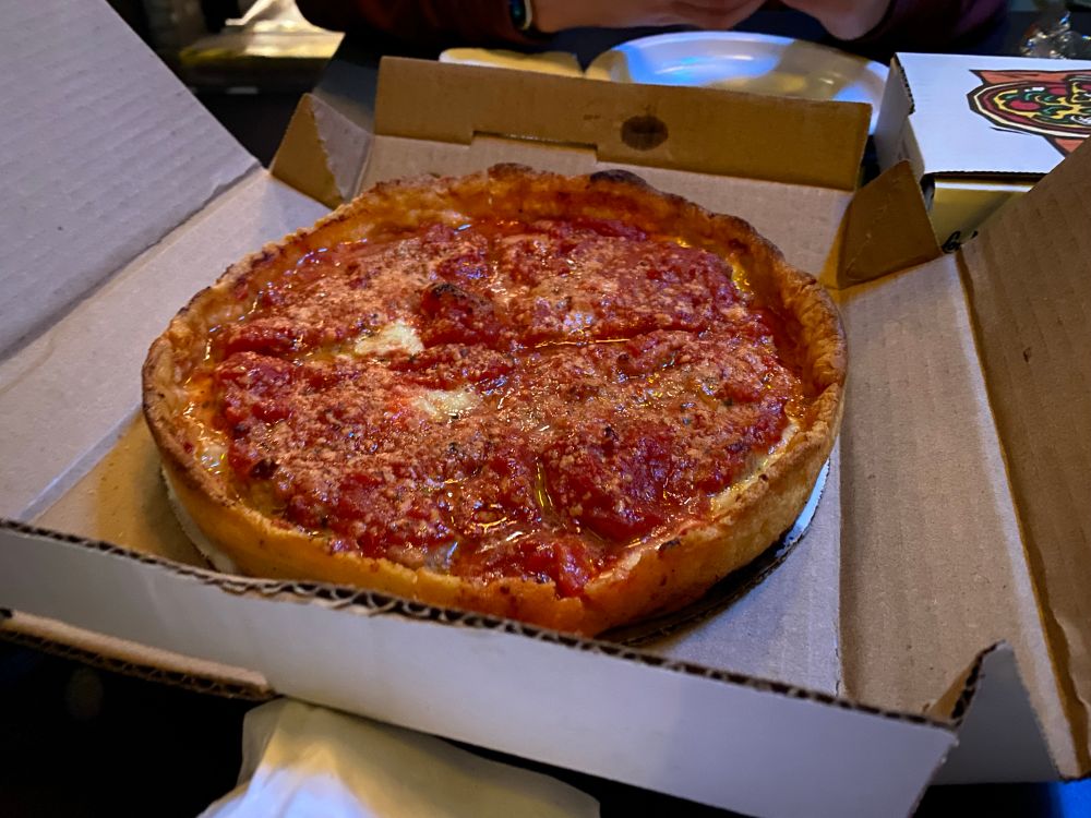 A deep dish in a box is depicted