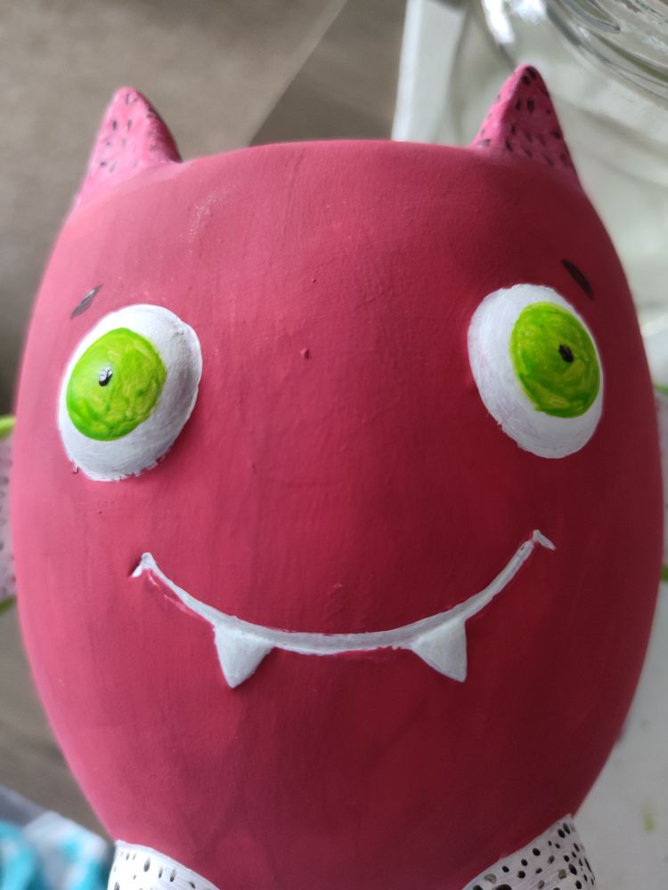 Smiling bat face with fangs