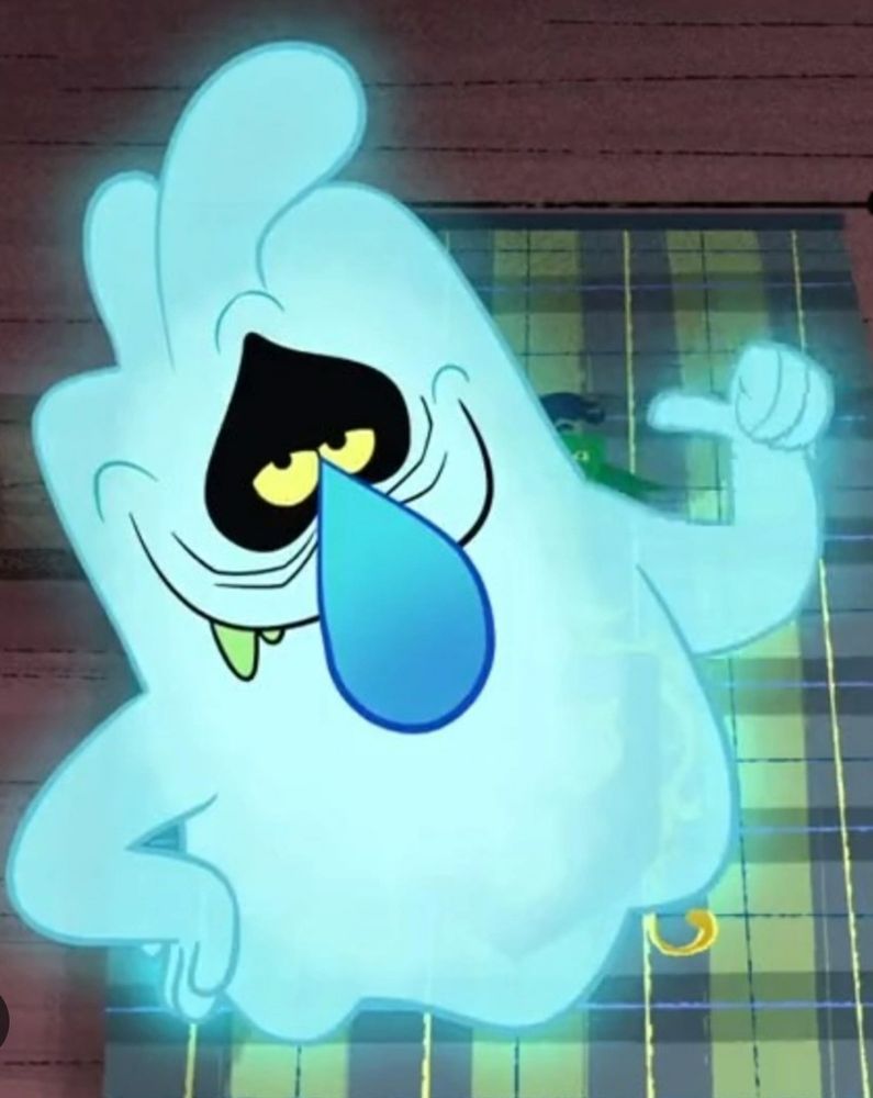 Blue smug see through pale blue ghost with green teeth, yellow eyes and black eyelids that encircled his eyes.