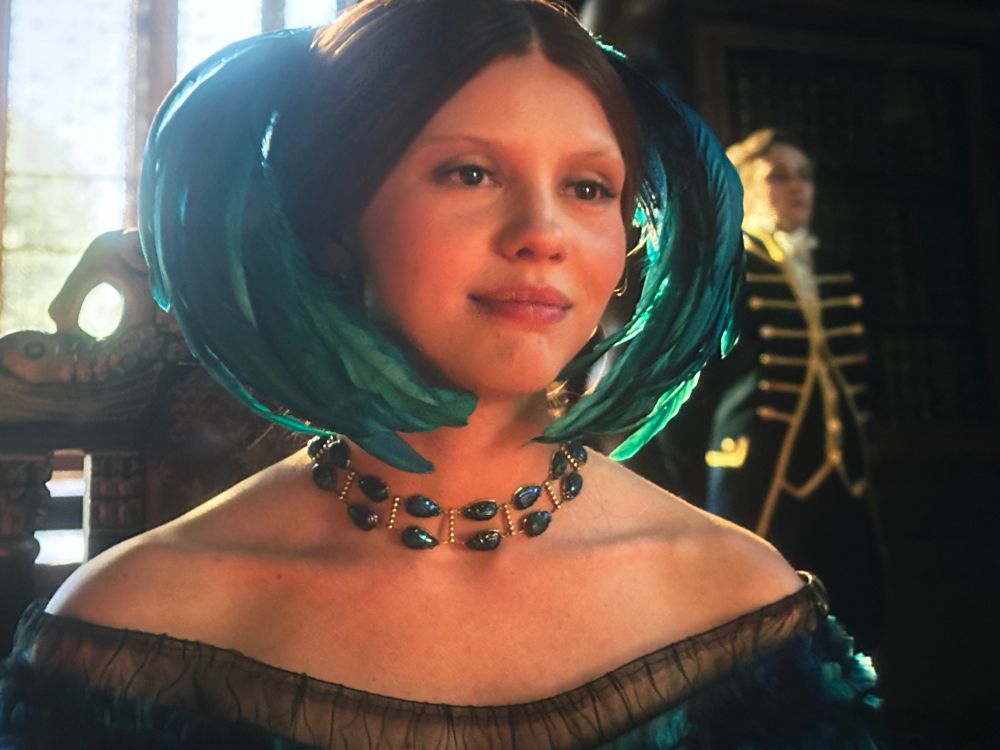Mia Goth as Elizabeth in Frankenstein, wearing a choker necklace made of beetles