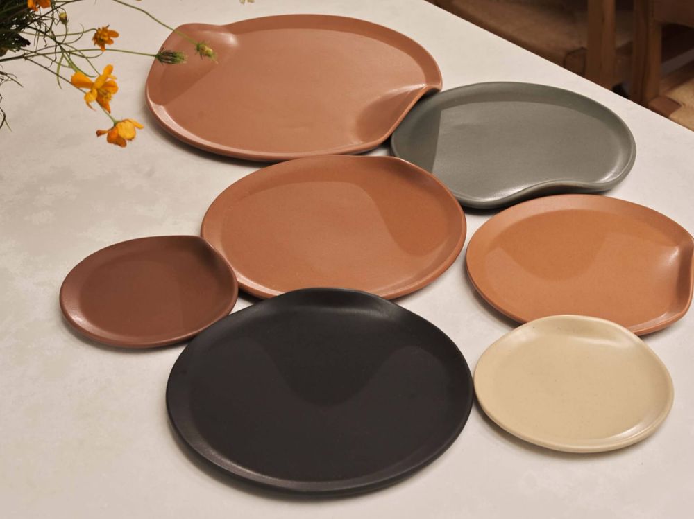 beautiful, thick ceramic plates gently push into each other