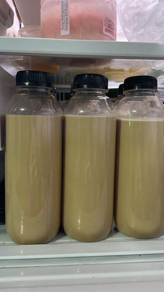 Bottles of latte inside a fridge 