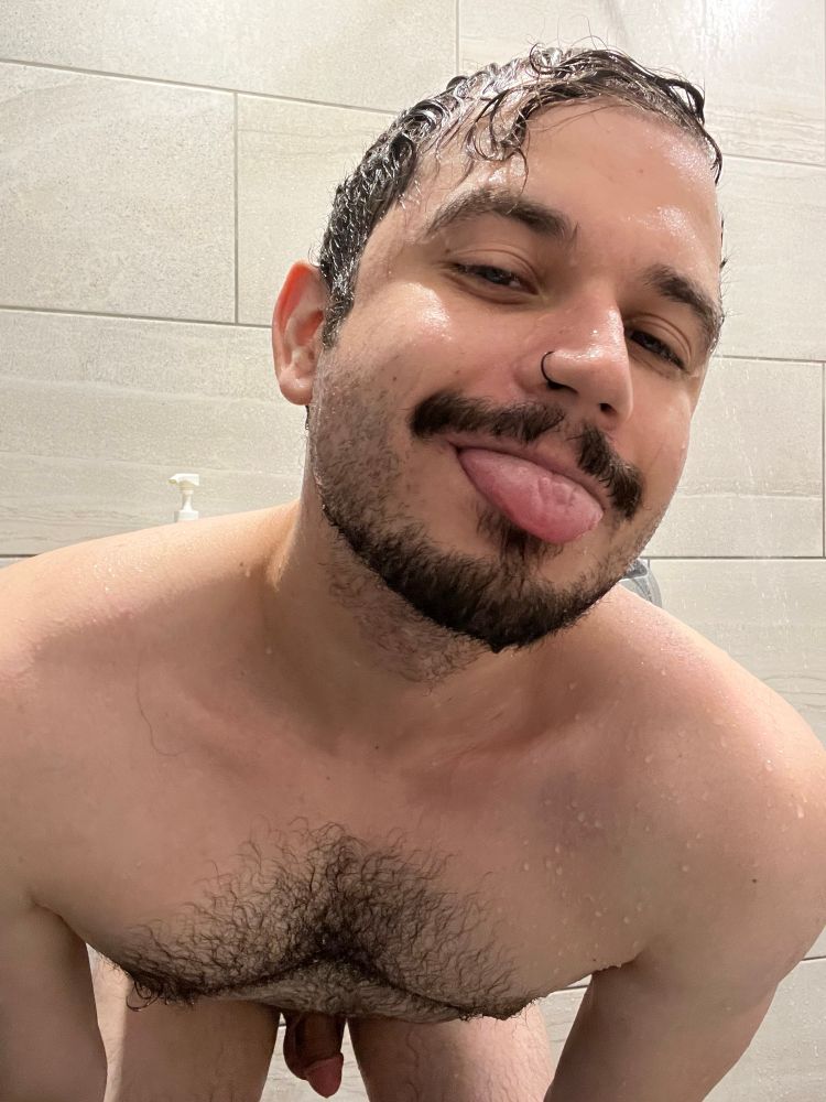 Rip shows off in the shower, bending toward the camera and sticking out their tongue. Their cleavage and soft cock are clearly visible in addition to the nose ring mentioned in the post