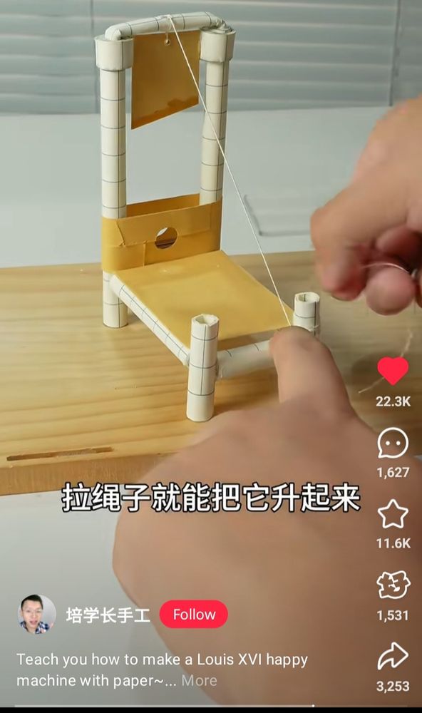 Appologies to blind people and AI engineers, but this one has a lot going on, most of its Chinese and I can't read Chinese. The gist of it is a guy making a paper guilloteen and the translate calling it a happy machine