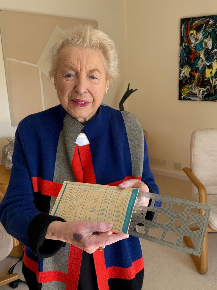 Dame Stephanie Shirley holding an IBM template used in coding in the early 1960s