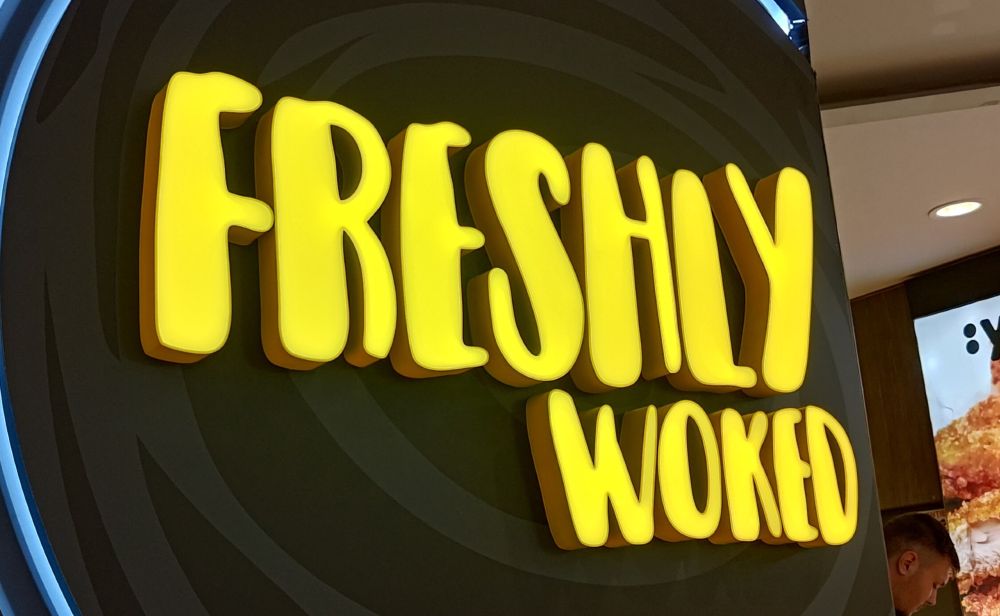 Picture of an asian restaurant's logo that reads "freshly woked"