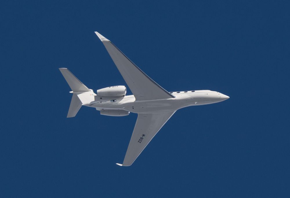 A sleek business jet against clear blue skies